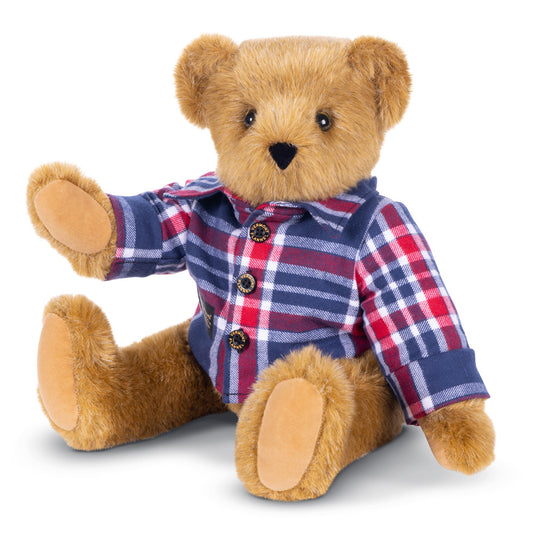 Honey-colored plush bear wearing a red and blue checkered flannel shirt sitting upright.