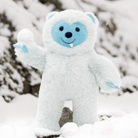 18-inch plush white yeti toy with blue face, black eyes, and small fangs standing in snow.