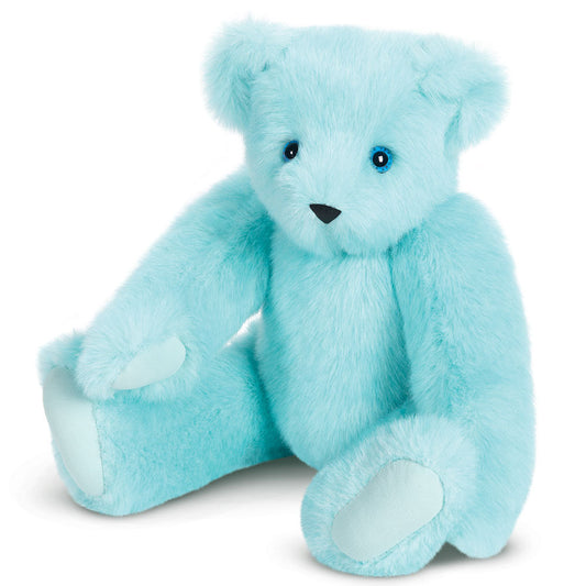 Soft light blue teddy bear with plush fur and stitched black eyes sitting upright.
