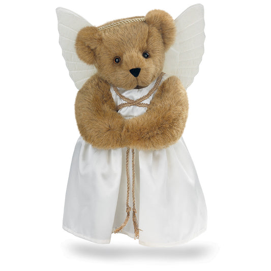 Honey-colored teddy bear with angel wings wearing a white dress and gold cord belt.