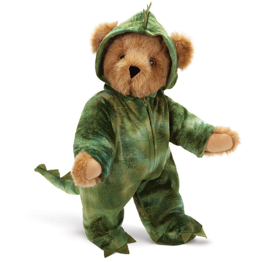 Honey-colored teddy bear wearing a green dinosaur costume with tail and hood.